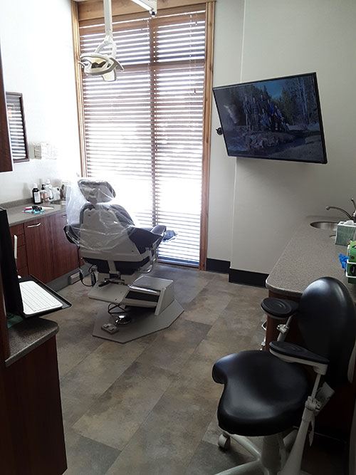 Suite Dental exam room with a large tv 1